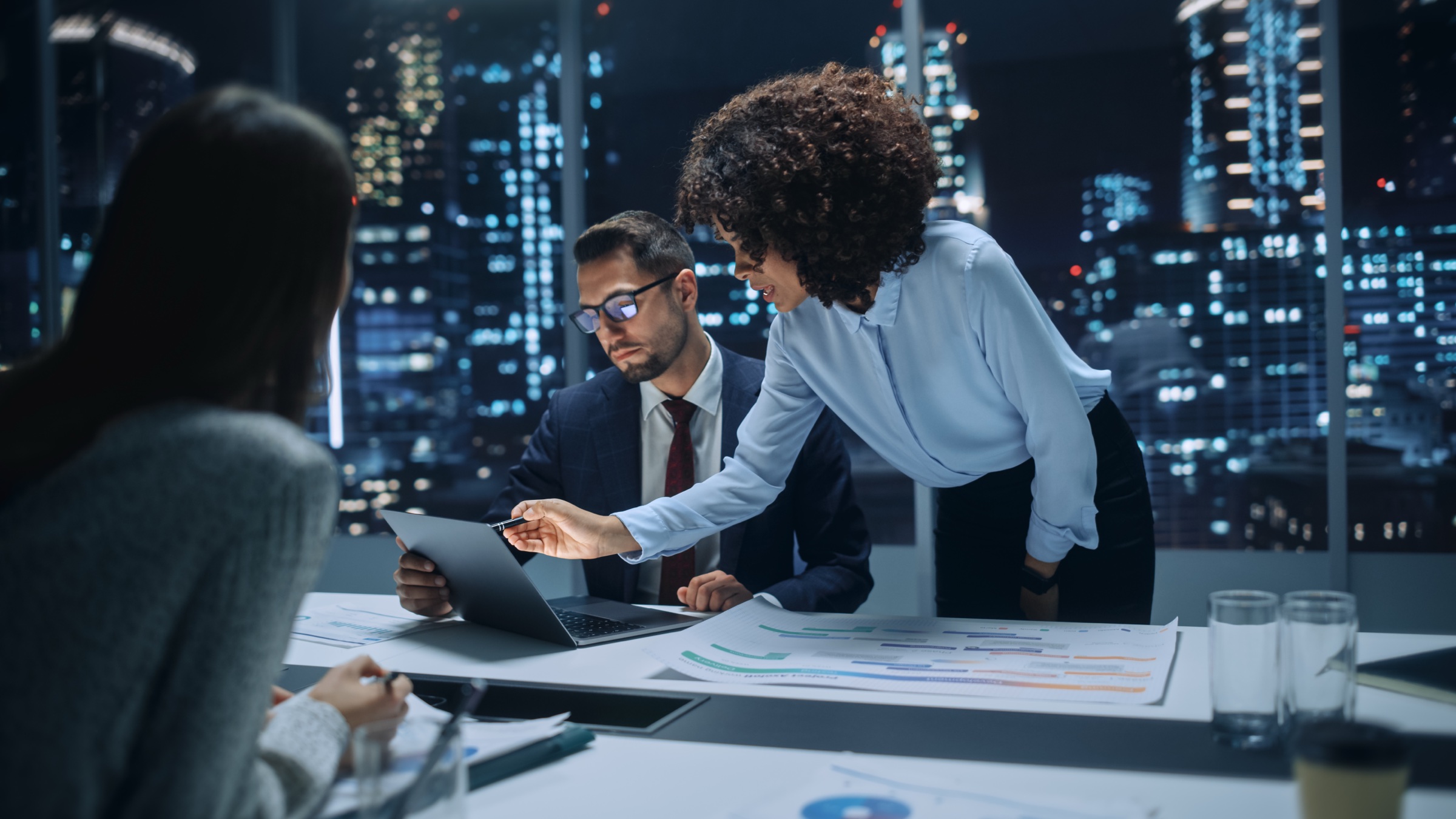 Senior managers reviewing financial reports during a boardroom meeting
